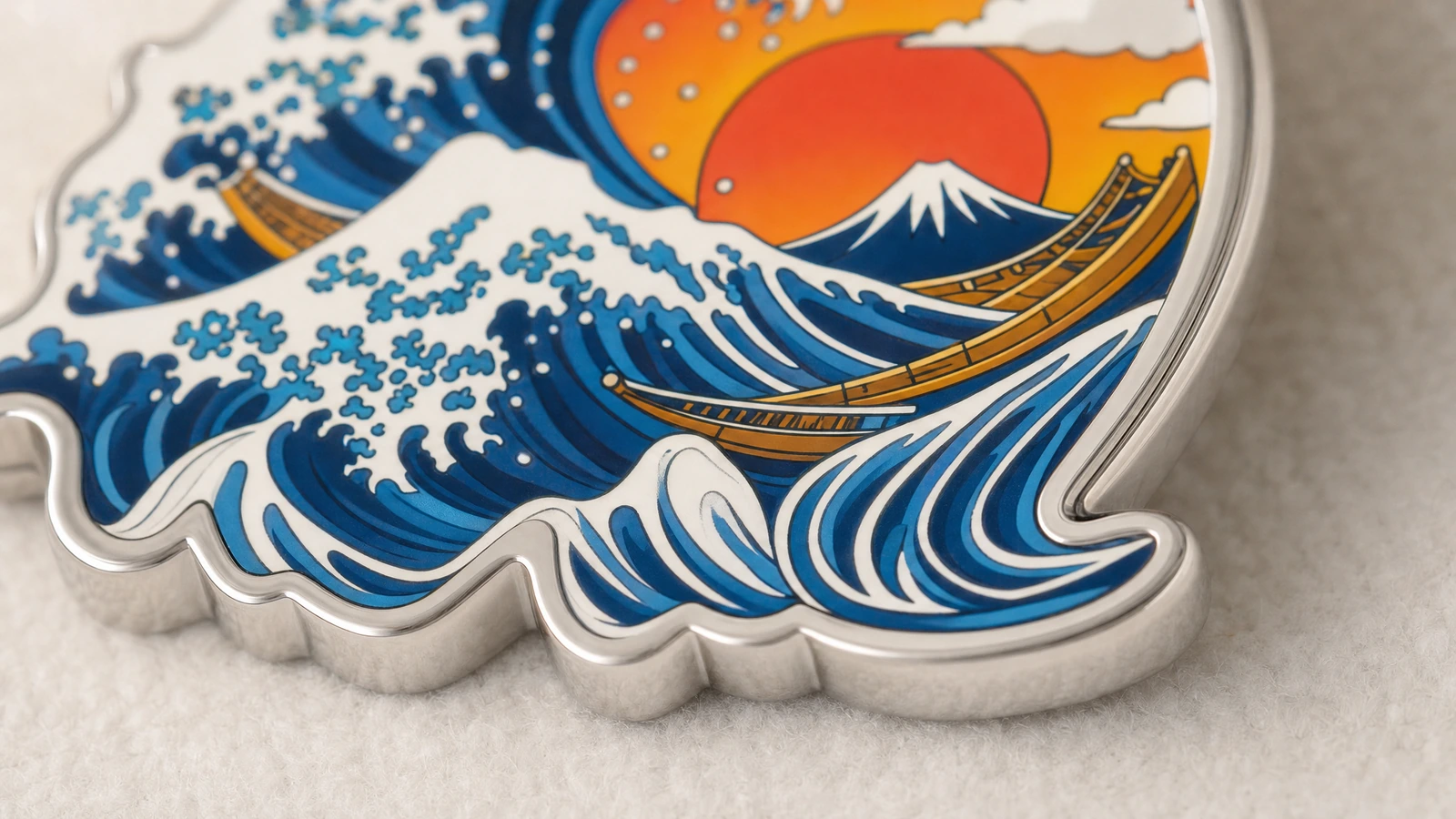 青い波、オレンジ色の太陽、山、ボートが描かれた成形金属製キーホルダーのクローズアップ